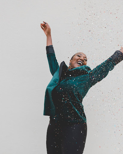 Joyful BL!SS babysitter celebrating with confetti
